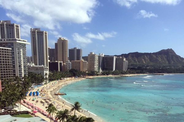 beach with turquoise water and tall buildings