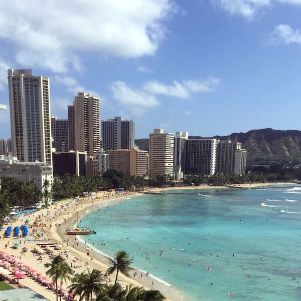 beach with turquoise water and tall buildings