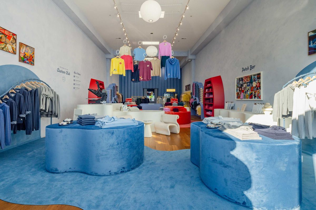 Bright, colorful clothing store interior with modern displays and hanging apparel.