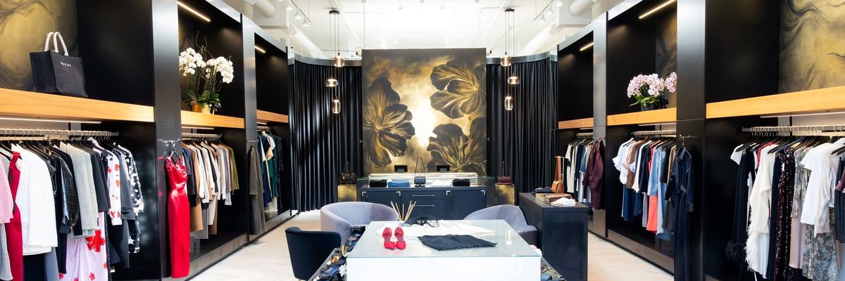 Chic boutique interior with stylish clothing racks and elegant decor elements.
