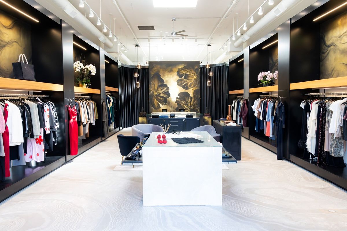 Chic boutique interior with stylish clothing racks and elegant decor elements.