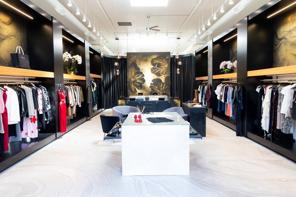Chic boutique interior with stylish clothing racks and elegant decor elements.