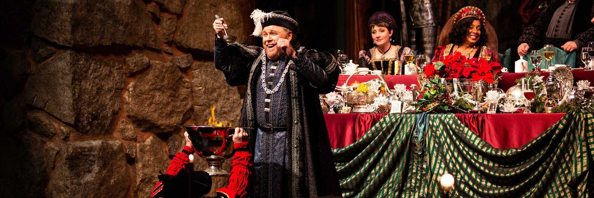 Festive medieval banquet with costumed performers and lavish table setting.