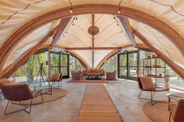 inside a huge tent with lounges and seating areas