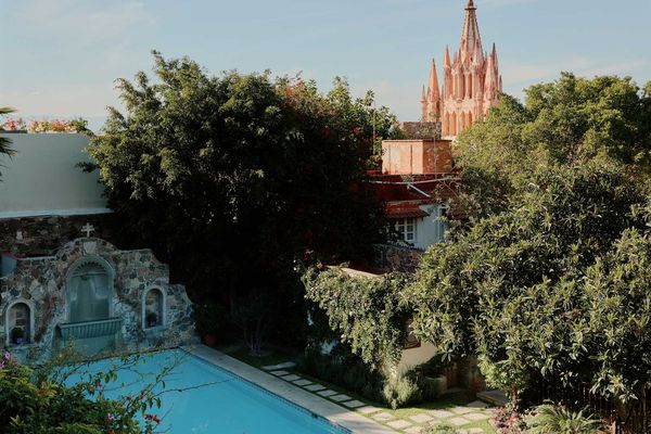 Mexican colonial pool with a gothic pink church in the background