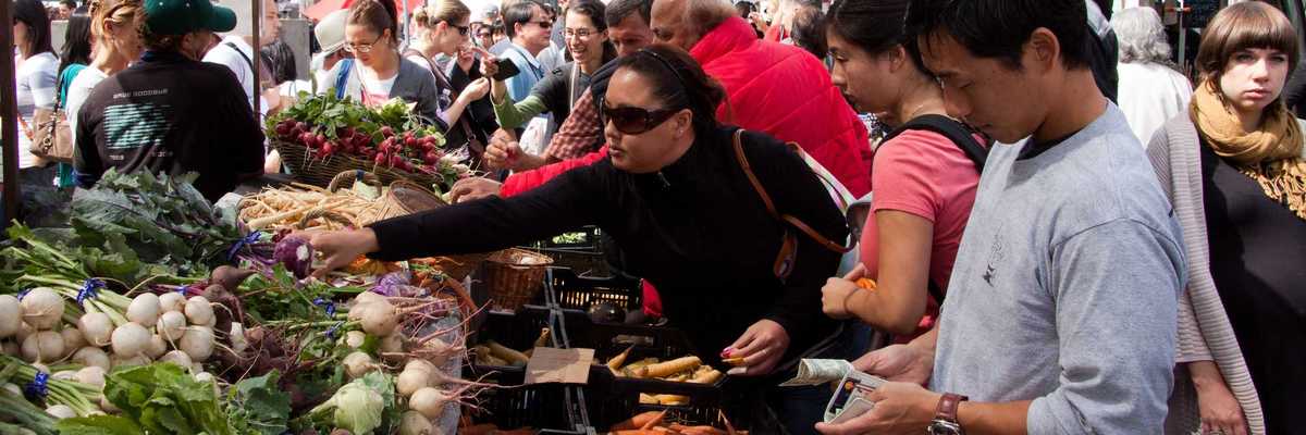 people buying produce at a farmers' market