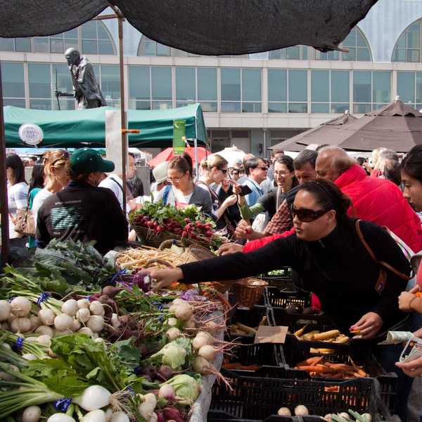 people buying produce at a farmers' market