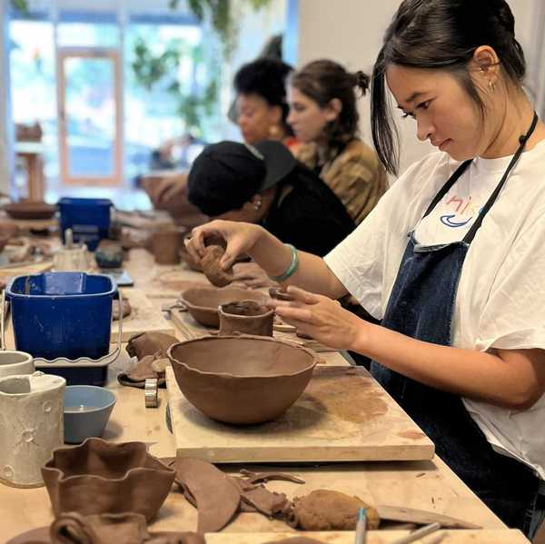 people in a class making dishes out of clay