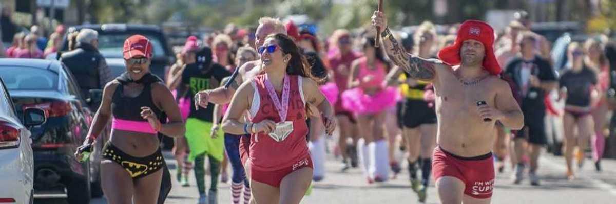 people running in their underwear, one with a cupid flag