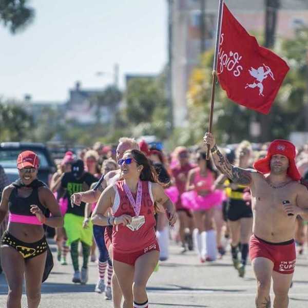 people running in their underwear, one with a cupid flag