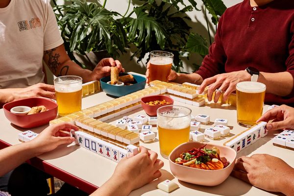 players at a mahjong table with food and beer