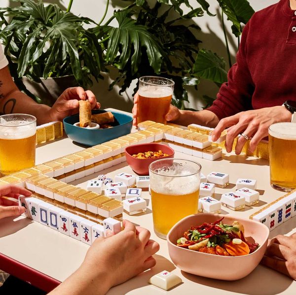 players at a mahjong table with food and beer