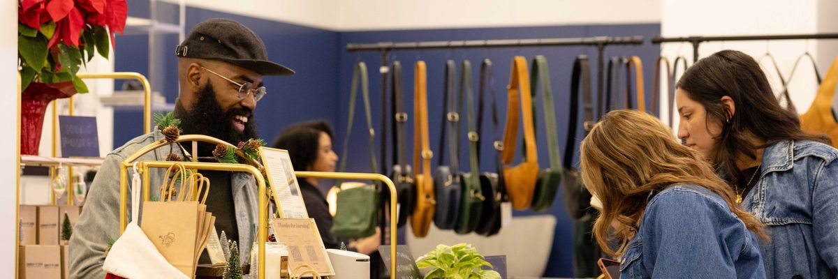 shoppers checking out at in a store decked for the holidays