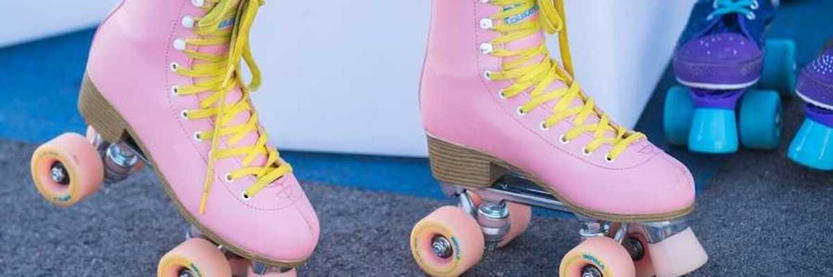 someone wearing a pair of pink retro roller skates