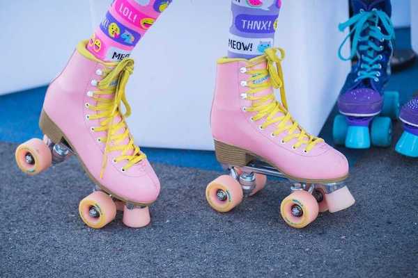 someone wearing a pair of pink retro roller skates