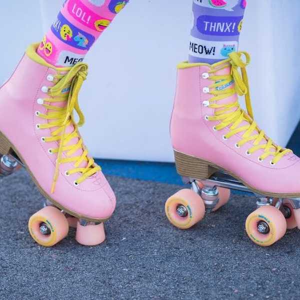 someone wearing a pair of pink retro roller skates