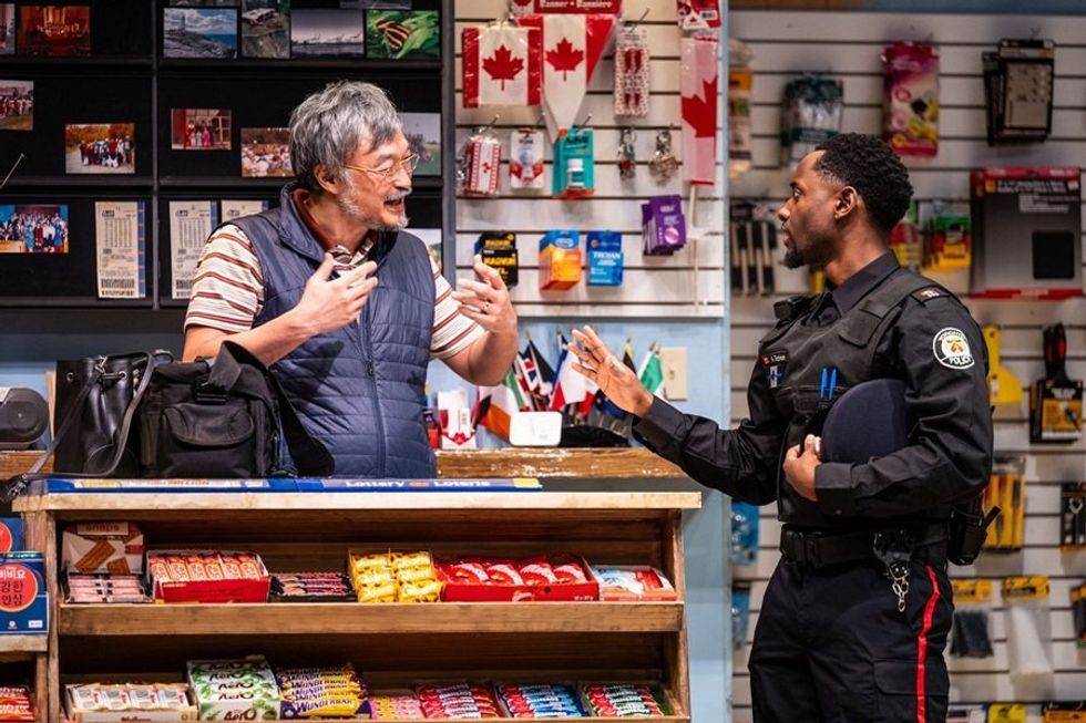 Store clerk and police officer conversing at a counter, surrounded by various products.