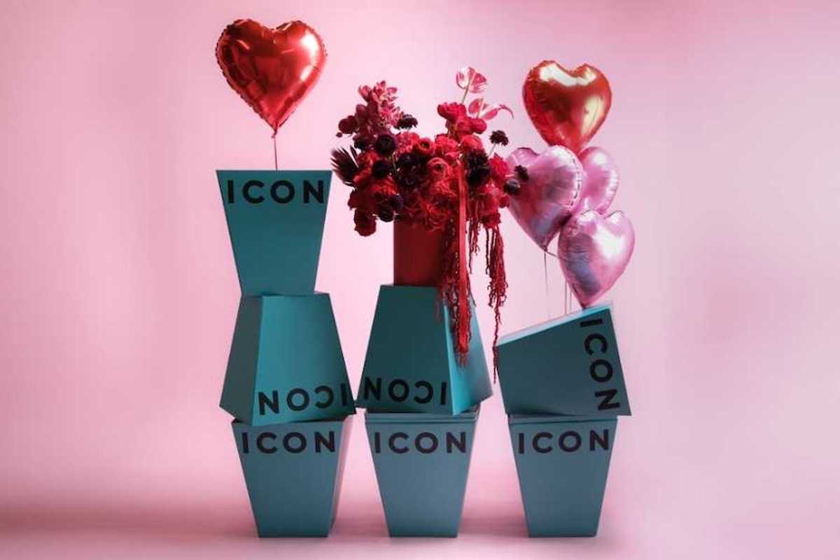 Turquoise vases that say icon on them and have flowers and balloons around them with a pink background