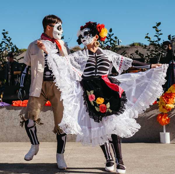 two people dressed as skeletons dancing