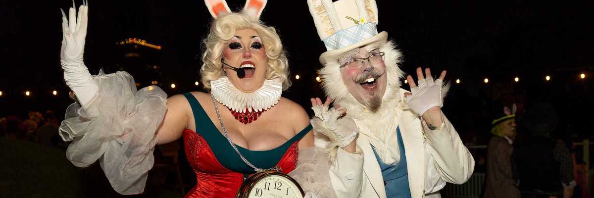 two people dressed like the rabbit from alice in wonderland
