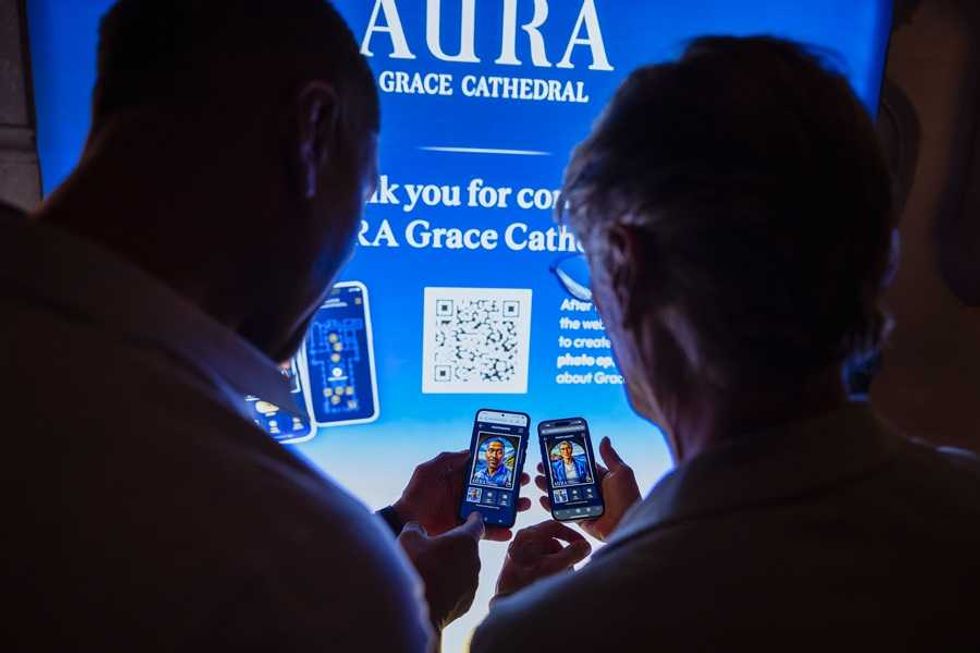 Two people using phones in front of a glowing blue cathedral sign.