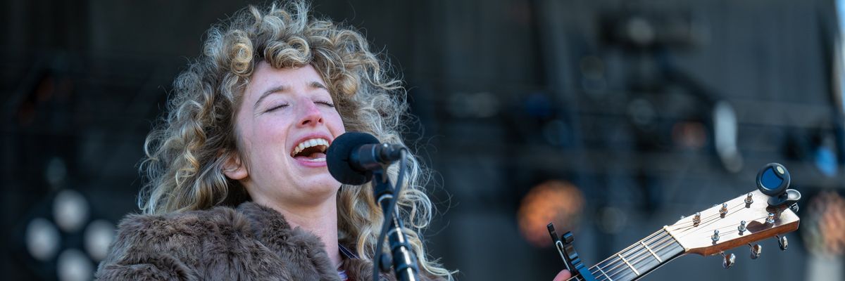 woman guitar player live music concert