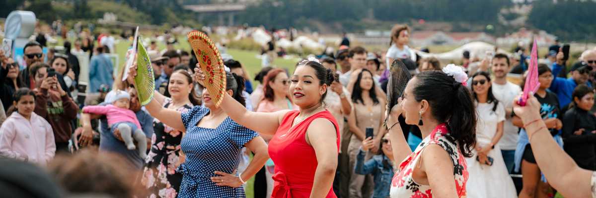 women dancing with fans in a park