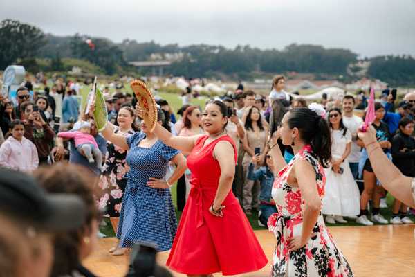 women dancing with fans in a park