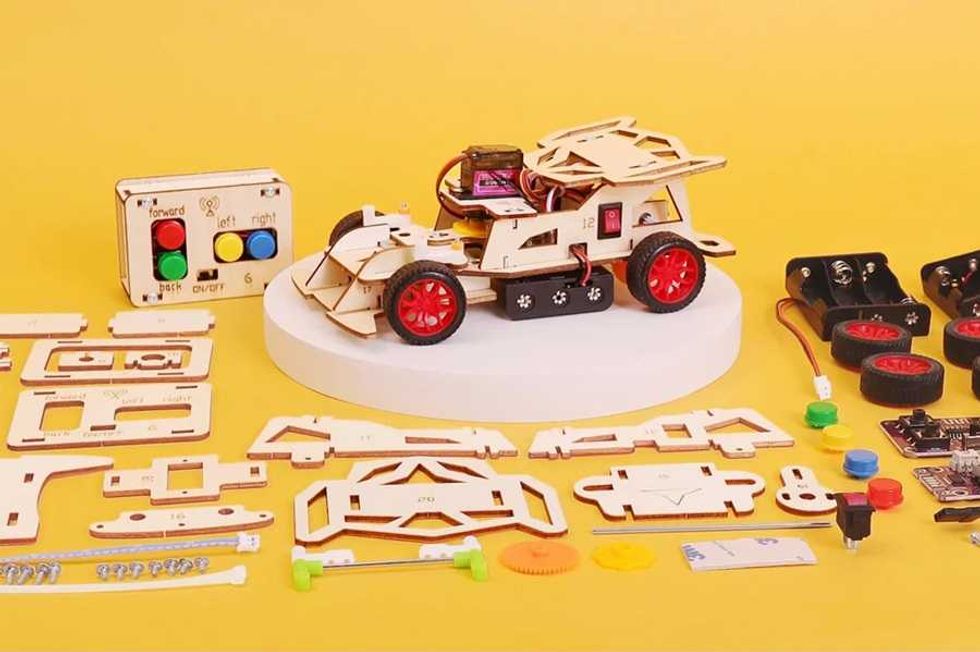 Wooden robot car kit with components, red wheels, and remote on yellow background.